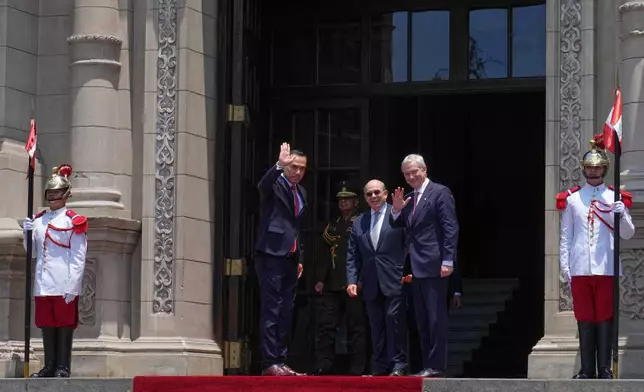 Peru's President Jose Jeri, left, and Chile's President-elect Jose Antonio Kast, right, wave to the press as Kast arrives at the government palace in Lima, Peru, Wednesday, Jan. 7, 2026. (AP Photo/Martin Mejia)