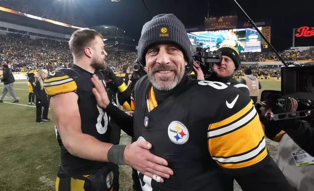 Pittsburgh Steelers quarterback Aaron Rodgers (8) greets tight end Pat Freiermuth (88) after an NFL football game against the Baltimore Ravens, Sunday, Jan. 4, 2026, in Pittsburgh. (AP Photo/Gene J. Puskar)