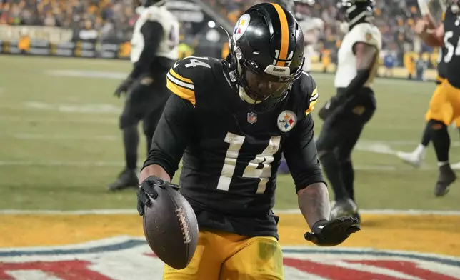 Pittsburgh Steelers running back Kenneth Gainwell (14) reacts after scoring a touchdown during the second half an NFL football game against the Baltimore Ravens, Sunday, Jan. 4, 2026, in Pittsburgh. (AP Photo/Gene J. Puskar)