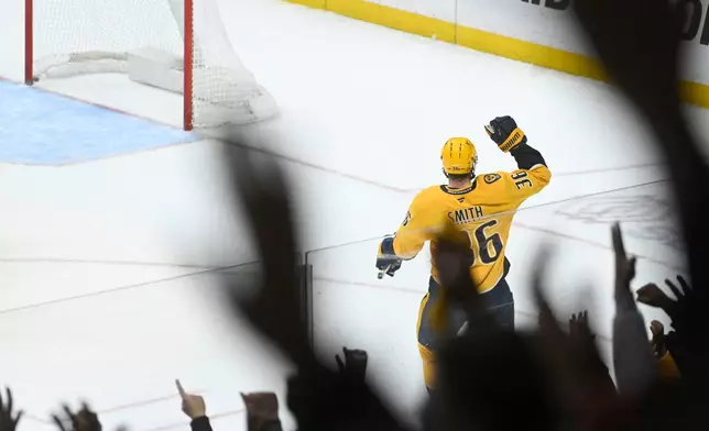 Nashville Predators left wing Cole Smith (36) and fans react after he scored against the Ottawa Senators during the third period of an NHL hockey game Thursday, Jan. 22, 2026, in Nashville, Tenn. (AP Photo/John Amis)