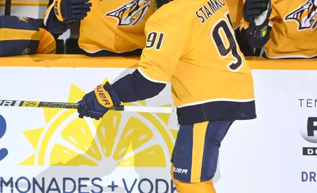 Nashville Predators center Steven Stamkos (91) celebrates with right wing Ozzy Wiesblatt (89) on the bench after scoring during the third period of an NHL hockey game Thursday, Jan. 22, 2026, in Nashville, Tenn. (AP Photo/John Amis)
