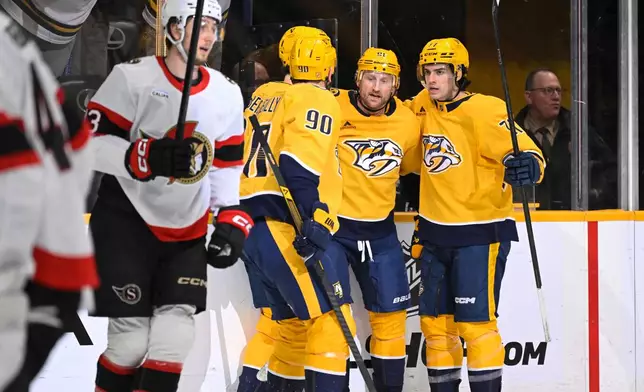 Nashville Predators center Steven Stamkos, second from right, celebrates after his goal with right wing Matthew Wood, right, and center Ryan O'Reilly (90) during the second period of an NHL hockey game against the Ottawa Senators, Thursday, Jan. 22, 2026, in Nashville, Tenn. (AP Photo/John Amis)