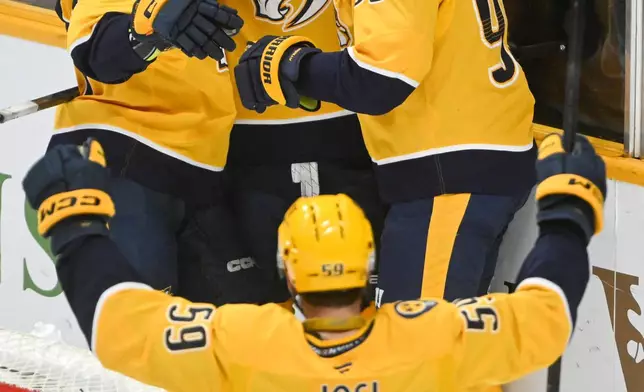 Nashville Predators center Steven Stamkos, rear center, celebrates after his goal with right wing Luke Evangelista, top left, center Ryan O'Reilly, top right, and defenseman Roman Josi (59) during the third period of an NHL hockey game against the Ottawa Senators, Thursday, Jan. 22, 2026, in Nashville, Tenn. (AP Photo/John Amis)