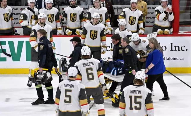 Winnipeg Jets' Haydn Fleury (24) is helped off the ice after being injured during the first period of an NHL hockey game against the Vegas Golden Knights in Winnipeg, Manitoba, Tuesday Jan. 6, 2026. (Fred Greenslade/The Canadian Press via AP)