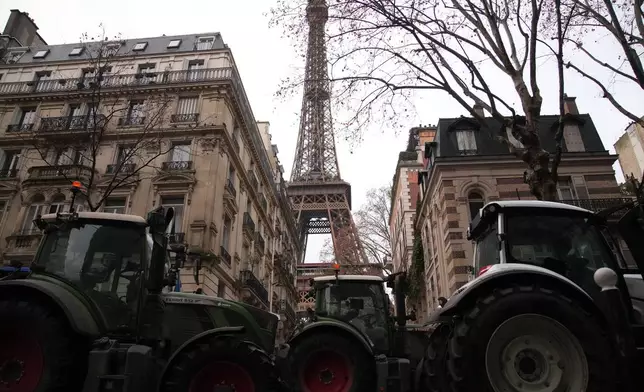 Tractors line up near the Eiffel Tower as farmers protest the European Union intention to move forward with the Mercosur trade deal with five South American nations, in Paris Thursday, Jan. 8, 2026 in Paris. (AP Photo/Christophe Ena)
