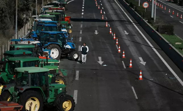 Tractors block a highway as farmers protest in Kastro, about 130 kilometers (81 miles) north of Athens, Greece, over delays in the payment of European Union-backed agricultural subsidies, on Thursday, Jan. 8 2025. (AP Photo/Thanassis Stavrakis)