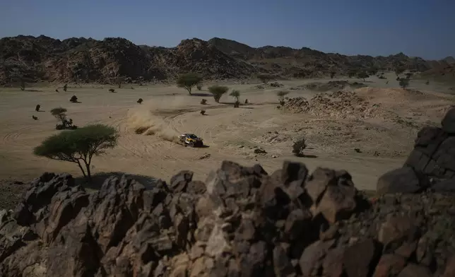 Driver Laia Sanz and co-driver Maurizio Gerini compete during the prologue of the Dakar Rally in Yanbu, Saudi Arabia, Saturday, Jan. 3, 2026. (AP Photo/Thibault Camus)