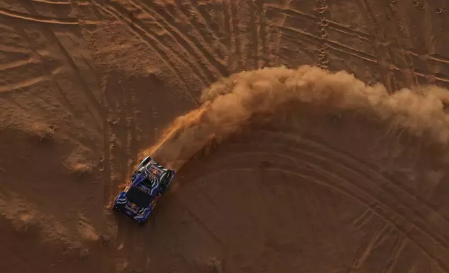 Driver Carlos Sainz and co-driver Lucas Cruz compete during the fourth stage of the Dakar Rally between Alula and Hail, Saudi Arabia, Wednesday, Jan. 7, 2026. (AP Photo/Thibault Camus)