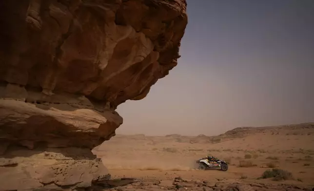 Driver Jeremias Gonzalez Ferioli and co-driver Gonzalo Rinaldi compete during the third stage of the Dakar Rally with a start and finish in Alula, Saudi Arabia, Tuesday, Jan. 6, 2026. (AP Photo/Thibault Camus)