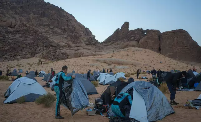 Drivers and co-drivers pack up their tents before the start of the fifth stage of the Dakar Rally between Alula and Hail, Saudi Arabia, Thursday, Jan. 8, 2026. (AP Photo/Thibault Camus)