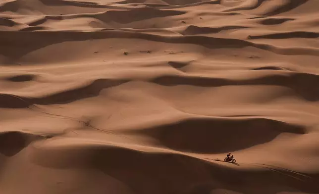 Rider Luciano Benavides competes during the seventh stage of the Dakar Rally between Riyadh and Wadi Ad Dawasir, Saudi Arabia, Sunday, Jan.11, 2026. (AP Photo/Thibault Camus)