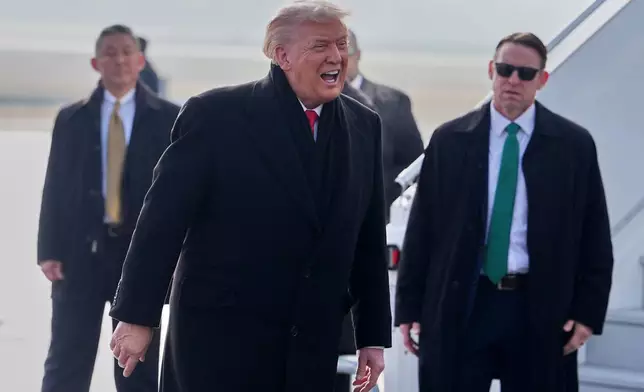 President Donald Trump, center, speaks as he steps off Air Force One after arriving at Zurich International Airport for the World Economic Forum, Wednesday, Jan. 21, 2026, in Zurich, Switzerland. (AP Photo/Evan Vucci)