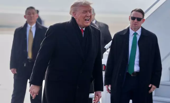 President Donald Trump, center, speaks as he steps off Air Force One after arriving at Zurich International Airport for the World Economic Forum, Wednesday, Jan. 21, 2026, in Zurich, Switzerland. (AP Photo/Evan Vucci)
