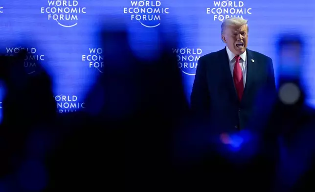 President Donald Trump walks on to the stage during the 56th annual meeting of the World Economic Forum, WEF, in Davos, Switzerland, Wednesday, Jan. 21, 2026. (Gian Ehrenzeller/Keystone via AP)