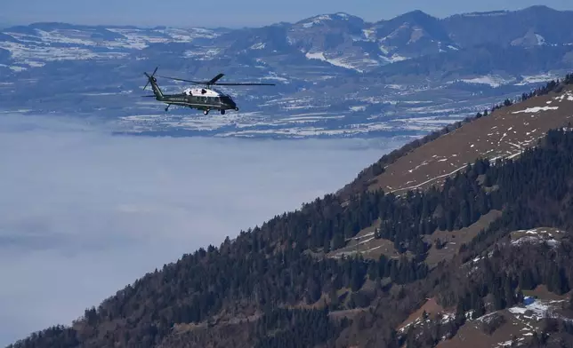 Marine One, carrying President Donald Trump, flies over snow covered mountains during his transfer to Davos after arriving at the airport in Zurich, Switzerland, Wednesday, Jan. 21, 2026. (AP Photo/Evan Vucci)