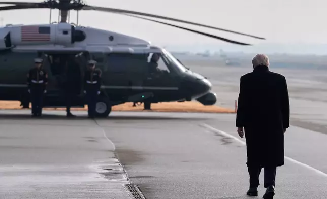President Donald Trump walks toward Marine One to transfer to Davos after arriving at the airport in Zurich, Switzerland, Wednesday, Jan. 21, 2026. (AP Photo/Evan Vucci)