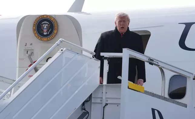 President Donald Trump steps off Air Force One after arriving at Zurich International Airport for the World Economic Forum, Wednesday, Jan. 21, 2026, in Zurich, Switzerland. (AP Photo/Evan Vucci)