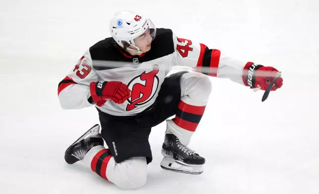 New Jersey Devils defenseman Luke Hughes celebrates his goal against the Columbus Blue Jackets during the third period of an NHL hockey game in Columbus, Ohio, Wednesday, Dec. 31, 2025. (AP Photo/Paul Vernon)