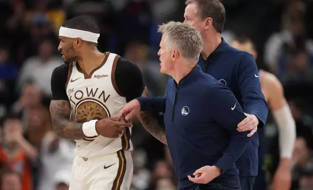 Golden State Warriors Head Coach Steve Kerr, center, is restrained by guard Gary Payton II (0) and assistant coach Terry Stotts as he argues with a referee during the second half of an NBA basketball game against the Los Angeles Clippers Monday, Jan. 5, 2026, in Inglewood, Calif. (AP Photo/Jae C. Hong)