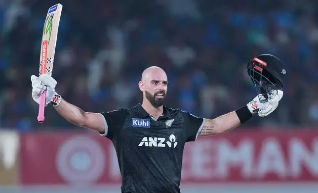 New Zealand's Daryl Mitchell celebrates after scoring a century during the second One Day International cricket match between India and New Zealand in Rajkot, India, Wednesday, Jan. 14, 2026. (AP Photo/Ajit Solanki)