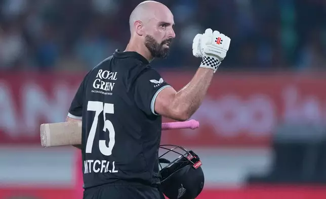 New Zealand's Daryl Mitchell celebrates after scoring a century during the second One Day International cricket match between India and New Zealand in Rajkot, India, Wednesday, Jan. 14, 2026. (AP Photo/Ajit Solanki)