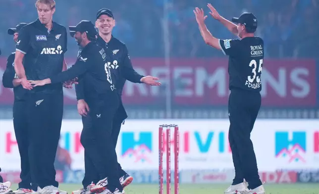 New Zealand's Kyle Jamieson, left, celebrates with teammates the wicket of India's Virat Kohli during the first One Day International cricket match between India and New Zealand in Vadodara, India, Sunday, Jan. 11, 2026. (AP Photo/Ajit Solanki)