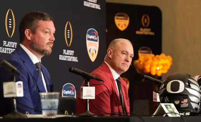 Texas Tech head coach Joey McGuire, right, and Oregon head coach Dan Lanning participate in a press conference ahead of the Orange Bowl College Football Playoff quarterfinal game, Wednesday, Dec. 31, 2025, in Dania Beach, Fla. (AP Photo/Rebecca Blackwell)