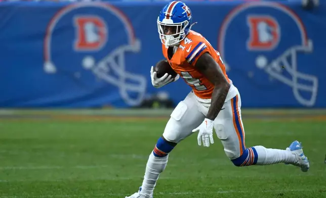 Denver Broncos wide receiver Courtland Sutton (14) runs against the Los Angeles Chargers during the second half of an NFL football game Sunday, Jan. 4, 2026, in Denver. (AP Photo/Eric Lutzens)