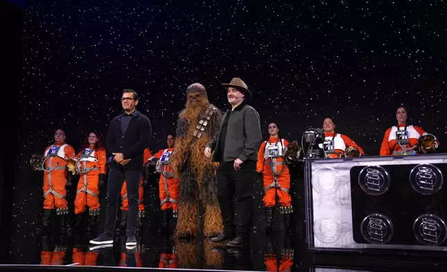 Asad Ayaz, left, and Dave Filioni stand on stage during an LEGO news conference ahead of the CES tech show Monday, Jan. 5, 2026, in Las Vegas. (AP Photo/Abbie Parr)
