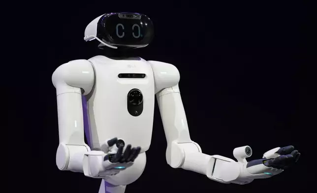 CLOiD, an LG Electronics home robot, interacts with the audience during an LG Electronics news conference ahead of the CES tech show Monday, Jan. 5, 2026, in Las Vegas. (AP Photo/Abbie Parr)