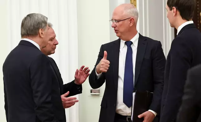 Kremlin foreign policy adviser Yuri Ushakov, left, U.S. President Donald Trump's envoy Steve Witkoff, second left, Putin's envoy Kirill Dmitriev, second right, and Trump's envoy Jared Kushner talk to each other prior to their meeting with Russian President Vladimir Putin at the Senate Palace of the Kremlin, in Moscow, Thursday, Jan. 22, 2026. (Alexander Kazakov/Sputnik, Kremlin Pool Photo via AP)