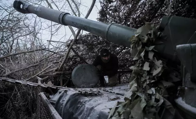 In this photo provided by Ukraine's 24th Mechanized Brigade press service, servicemen fire a 2S1 Gvozdika self propelled howitzer towards Russian positions near Chasiv Yar town, Donetsk region, Ukraine, Sunday, Jan. 18, 2026. (Oleg Petrasiuk/Ukraine's 24th Mechanized Brigade via AP)