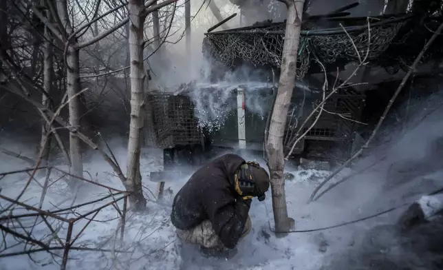 In this photo provided by Ukraine's 24th Mechanized Brigade press service, servicemen fire a 2S1 Gvozdika self propelled howitzer towards Russian positions near Chasiv Yar town, Donetsk region, Ukraine, Sunday, Jan. 18, 2026. (Oleg Petrasiuk/Ukraine's 24th Mechanized Brigade via AP)