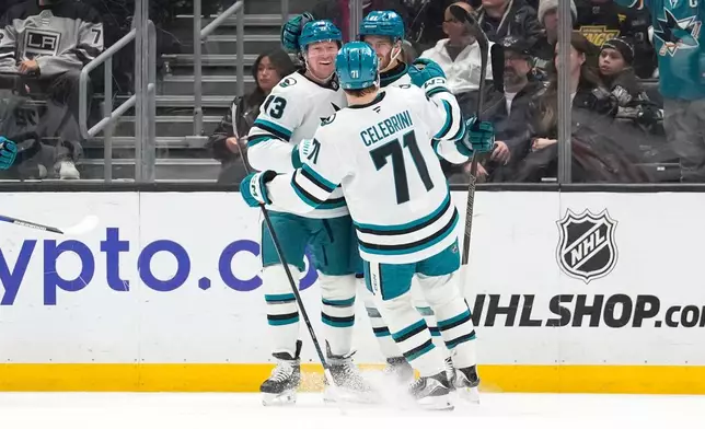San Jose Sharks center Tyler Toffoli, left, celebrates his goal with center MacKlin Celebrini, center and center Alexander Wennberg during the second period of an NHL hockey game against the Los Angeles Kings, Wednesday, Jan. 7, 2026, in Los Angeles. (AP Photo/Mark J. Terrill)