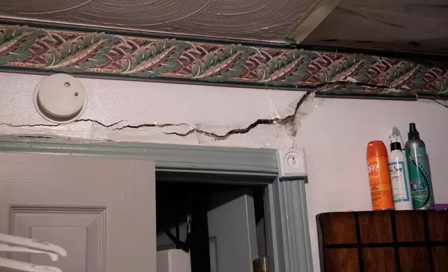 A crack is visible on the wall of Yvette Lyles' home where she says flooding has caused significant damage in Cahokia Heights, Ill., May 15, 2025. (AP Photo/Michael Phillis)