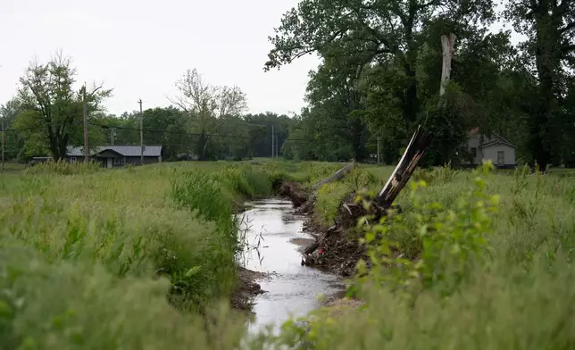 Water flows near homes in flood-prone Cahokia Heights, Ill., May 15, 2025. (AP Photo/Michael Phillis)