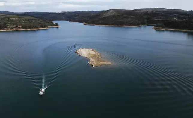 An islet that recently emerged is seen at Lake Marathon near Athens, Greece, on Tuesday, Jan. 6, 2026, as receding water levels reflect years of low rainfall. (AP Photo/Thanassis Stavrakis)