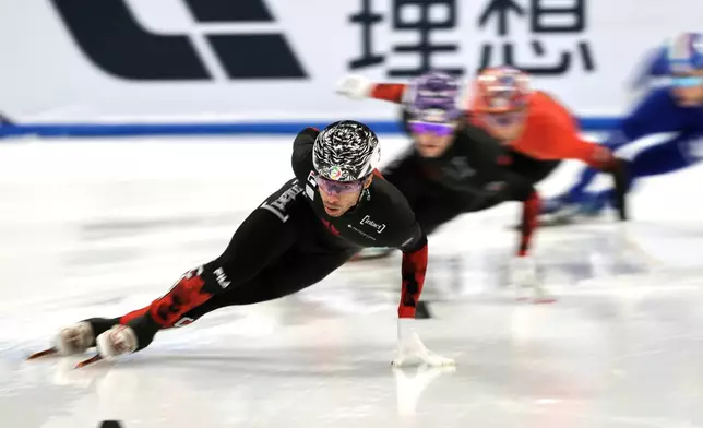 FILE - William Dandjinou of Canada leads in the Men's 1000m Quarterfinals Heat 2 for the ISU World Short Track Championships held at the Capital Indoor Stadium in Beijing, Sunday, March 16, 2025. (AP Photo/Andy Wong, File)