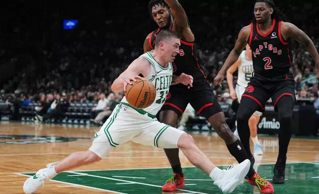 Boston Celtics guard Payton Pritchard (11) drives to the basket against the Toronto Raptors during the second half of an NBA basketball game, Friday, Jan. 9, 2026, in Boston. (AP Photo/Charles Krupa)