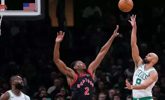 Boston Celtics guard Derrick White (9) takes a shot over Toronto Raptors forward Jonathan Mogbo (2) during the first half of an NBA game, Friday, Jan. 9, 2026, in Boston. (AP Photo/Charles Krupa)