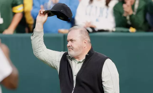 FILE - Former Green Bay Packers head coach Mike McCarthy waves during halftime of an NFL football game against the Detroit Lions Sunday, Sept. 7, 2025, in Green Bay, Wis. (AP Photo/Matt Ludtke, File)