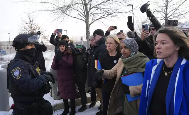Rep. Kelly Morrison D-Minn., center, Rep. Ilhan Omar, D-Minn., second from the right, and Rep. Angie Craig, D-Minn., far right, at the Bishop Whipple Federal Building, Saturday, Jan. 10, 2026, in Minneapolis. (AP Photo/Adam Gray)