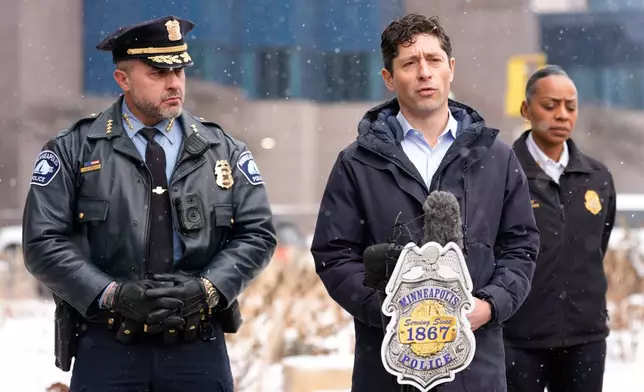 Minneapolis Mayor Jacob Frey holds a news conference as Police Chief Brian O'Hara listens, on Saturday, Jan. 10, 2026, in Minneapolis. (AP Photo/Jen Golbeck)