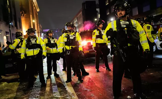 Minnesota State Patrol officers are seen during a protest and noise demonstration calling for an end to federal immigration enforcement operations in the city, Friday, Jan. 9, 2026, in Minneapolis. (AP Photo/John Locher)