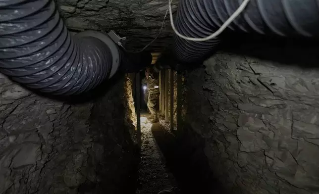 FILE - Lebanese army soldiers walk through a tunnel dug into a mountain that was used by Hezbollah militants as a clinic and storage facility near the Lebanese-Israeli border in the Zibqin Valley, southern Lebanon, Nov. 28, 2025. (AP Photo/Bilal Hussein, File)