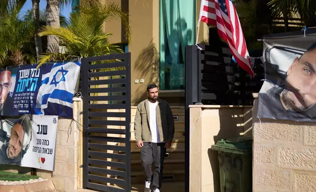 Segev Kalfon, an Israeli hostage who spent two years in captivity in a Hamas tunnel and was released from the Gaza Strip in a ceasefire deal on Oct. 13, steps out of his home in Dimona, southern Israel, Tuesday, Dec. 23, 2025. (AP Photo/Ariel Schalit)