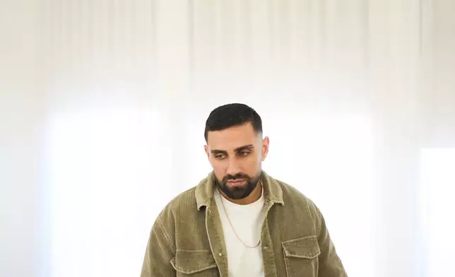 Segev Kalfon, an Israeli hostage who spent two years in captivity in a Hamas tunnel and was released from the Gaza Strip in a ceasefire deal on Oct. 13, looks on at his home in Dimona, southern Israel, Tuesday, Dec. 23, 2025. (AP Photo/Ariel Schalit)