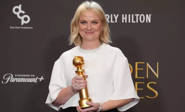 Amy Poehler poses in the press room with the award for best podcast for "Good Hang with Amy Poehler during the 83rd Golden Globes on Sunday, Jan. 11, 2026, at the Beverly Hilton in Beverly Hills, Calif. (AP Photo/Chris Pizzello)