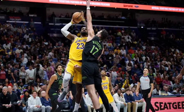 Los Angeles Lakers forward LeBron James (23) shoots against New Orleans Pelicans forward Karlo Matkovic (17) during the second half of an NBA basketball game in New Orleans, Tuesday, Jan. 6, 2026. (AP Photo/Matthew Hinton)