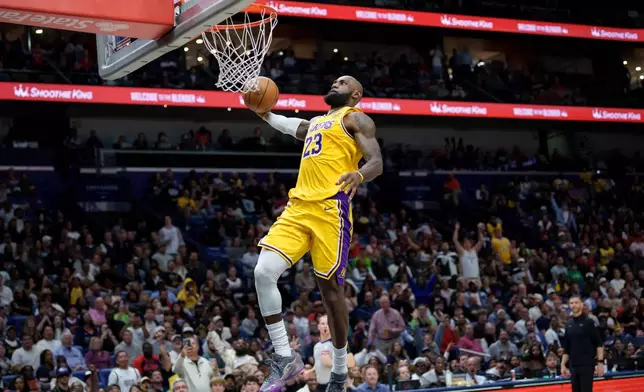 Los Angeles Lakers forward LeBron James (23) breaks free for a dunk against the New Orleans Pelicans during the second half of an NBA basketball game in New Orleans, Tuesday, Jan. 6, 2026. (AP Photo/Matthew Hinton)